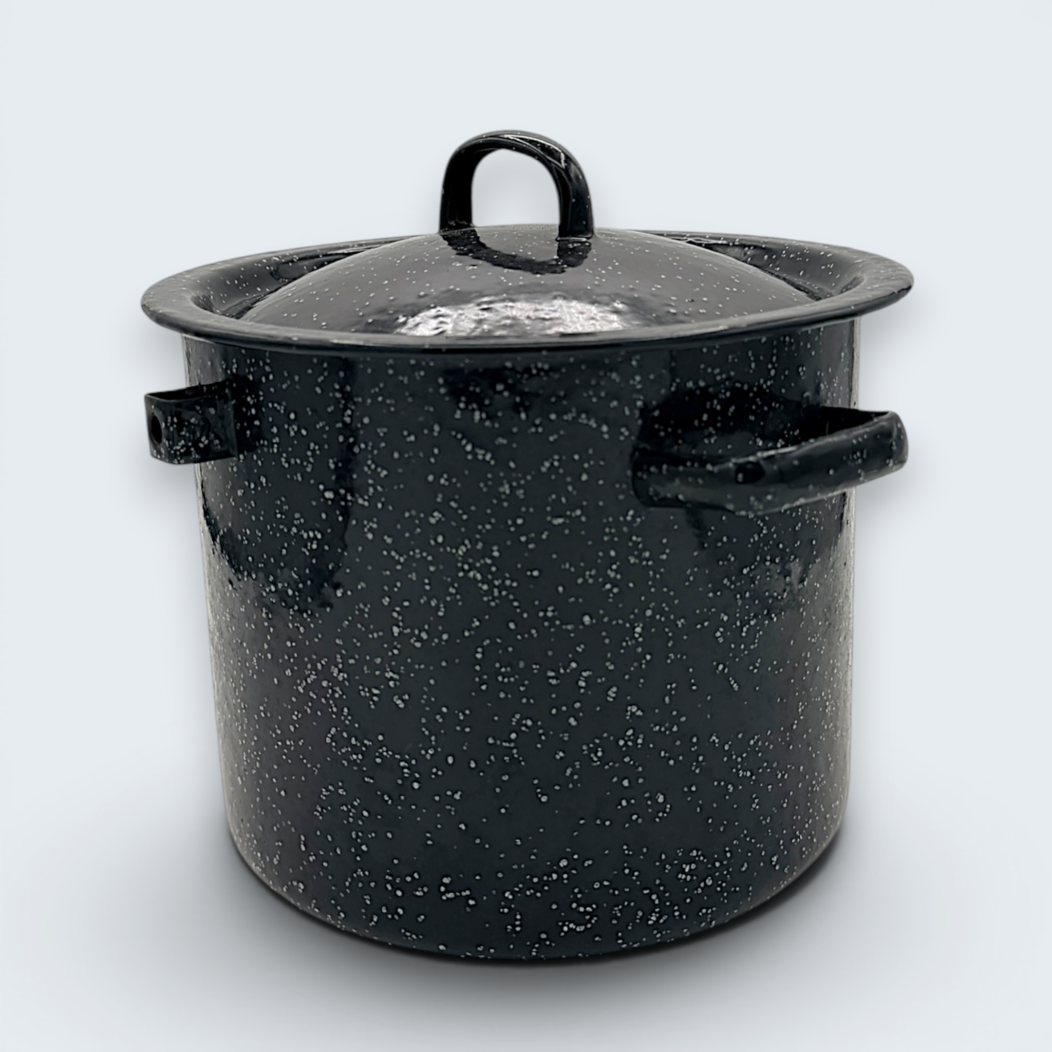 A vintage black speckled enamelware stock pot with a matching lid, featuring a classic white spatter pattern over a glossy black finish and sturdy handles. - Photo 8