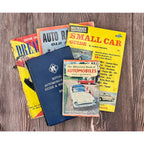 Collection of vintage car books on a wooden surface