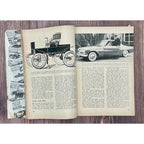 Open book with vintage car illustrations and text on a wooden surface
