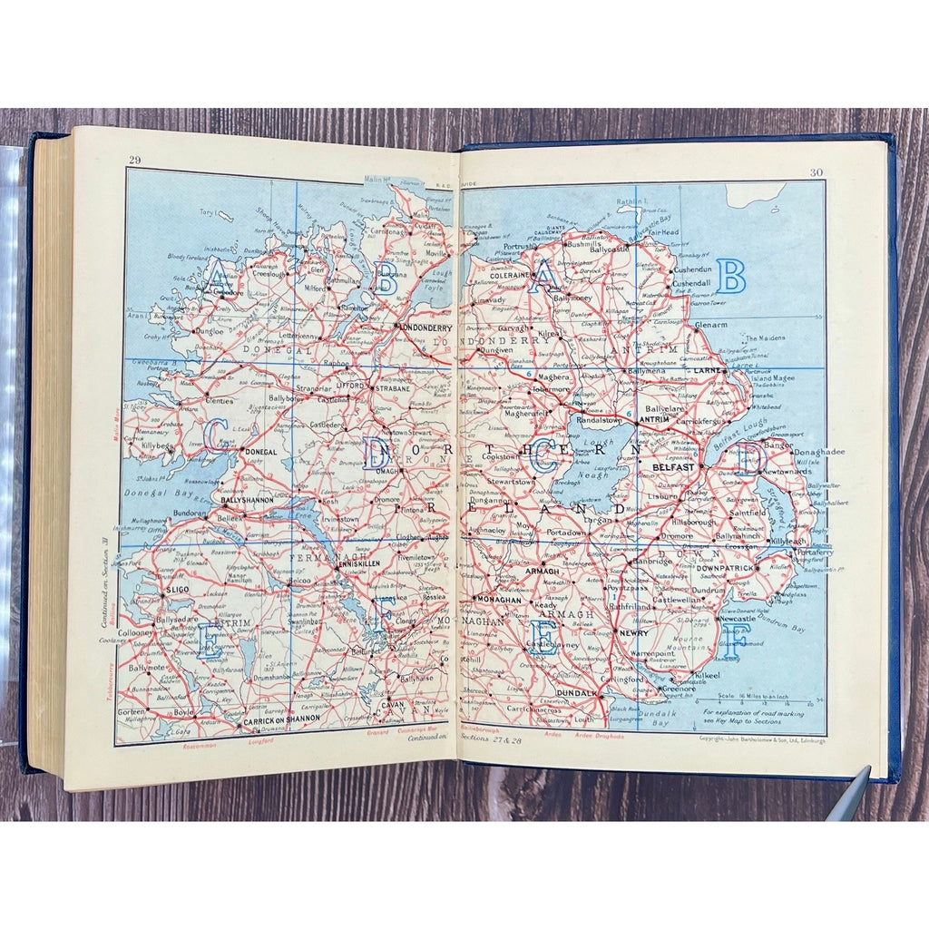 Open book displaying a map of Ireland on a wooden surface