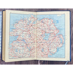 Open book displaying a map of Ireland on a wooden surface