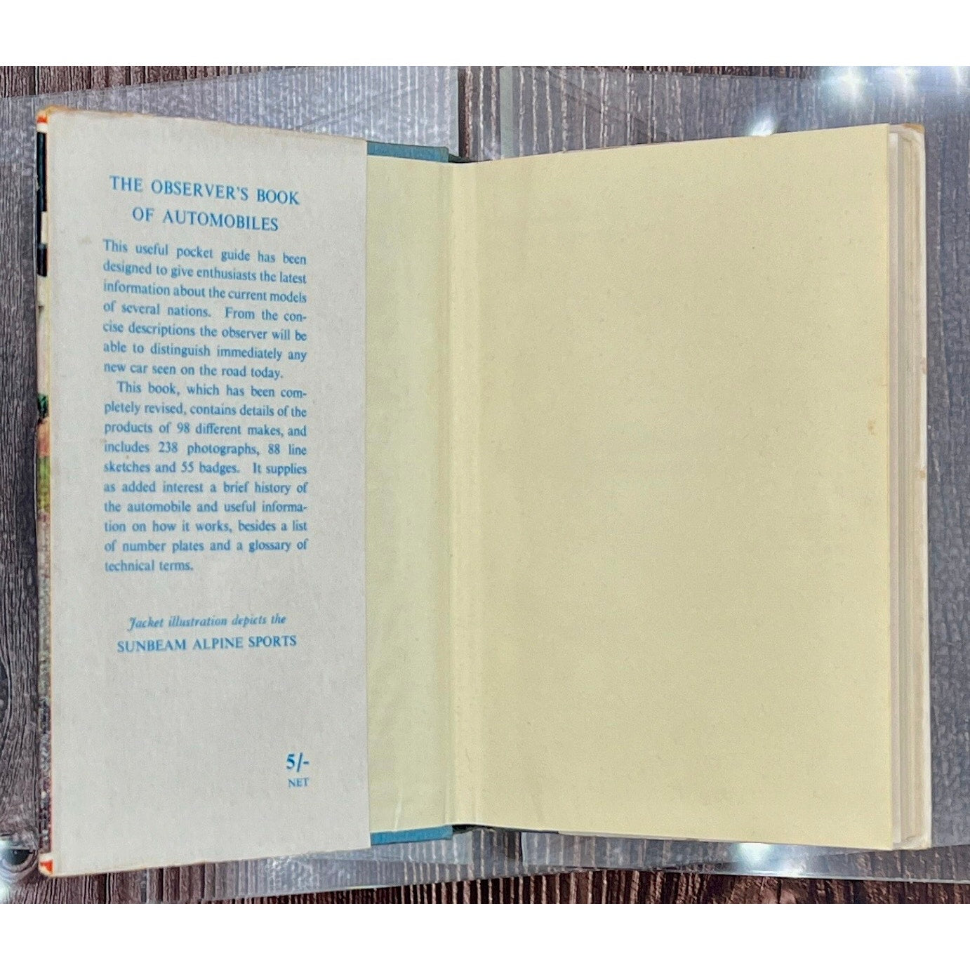 Open book with text on a wooden surface