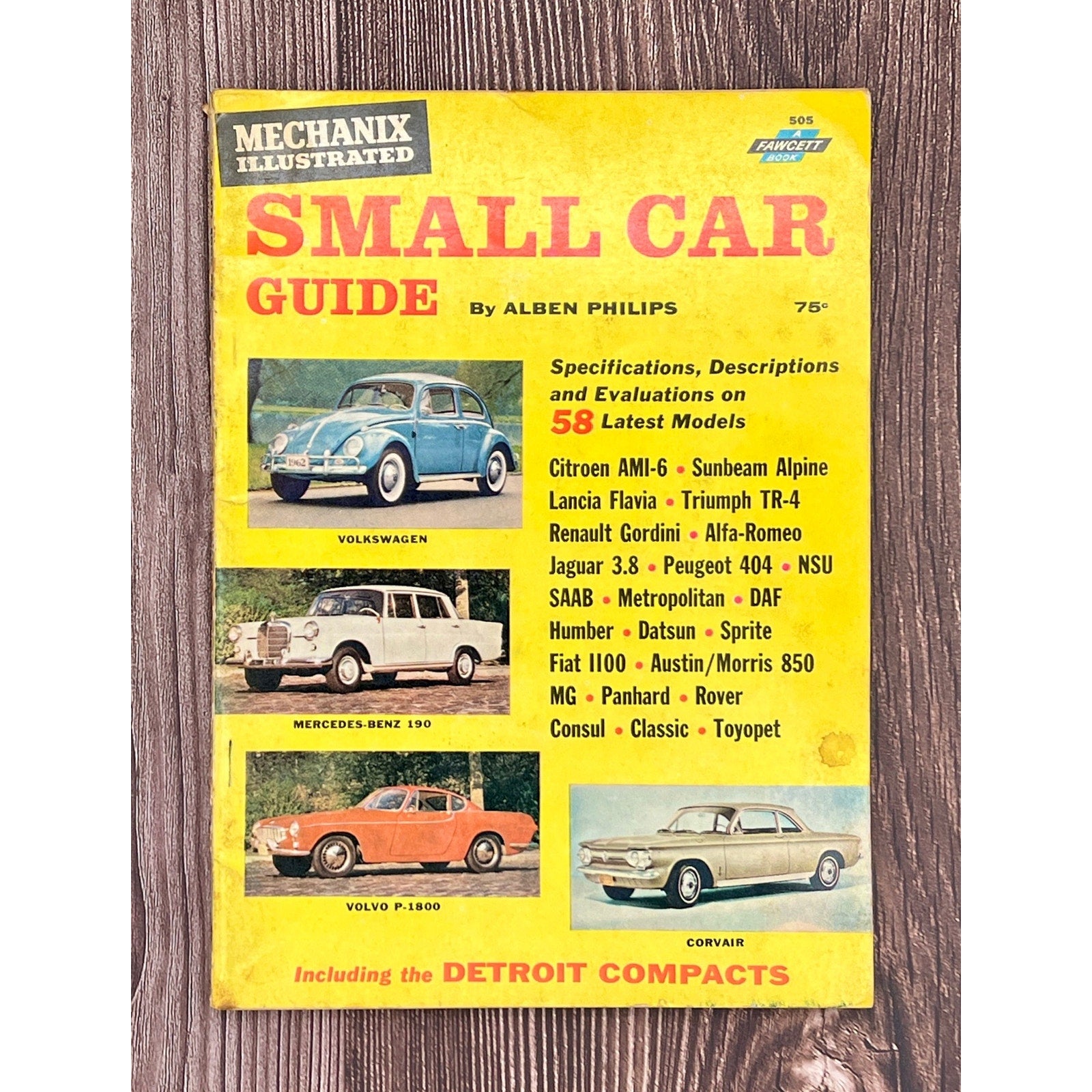 Book cover of 'Mechanix Illustrated Small Car Guide' on a wooden surface