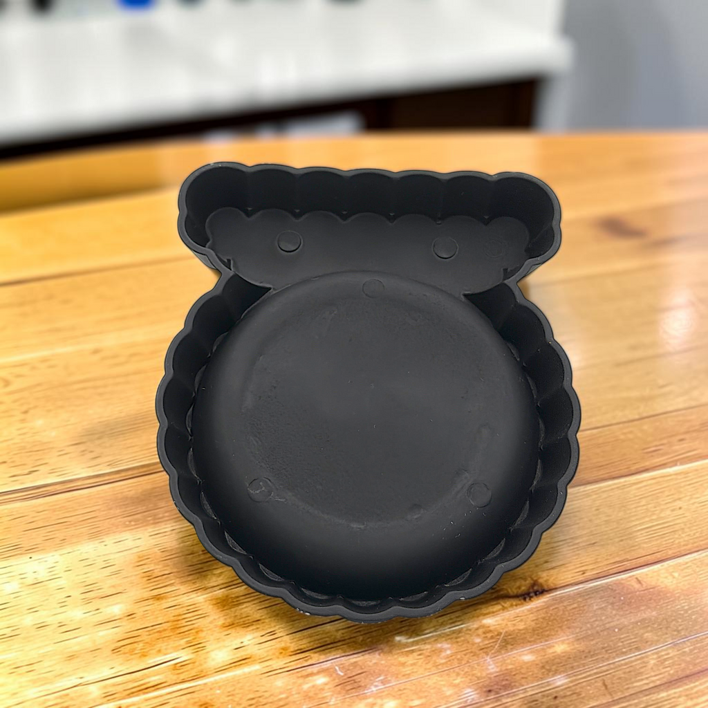A black cast iron camel figurine featuring a four-prong saddle holder for cigarette packs, attached to a scalloped base with a removable clear glass ashtray dish. - Photo 9