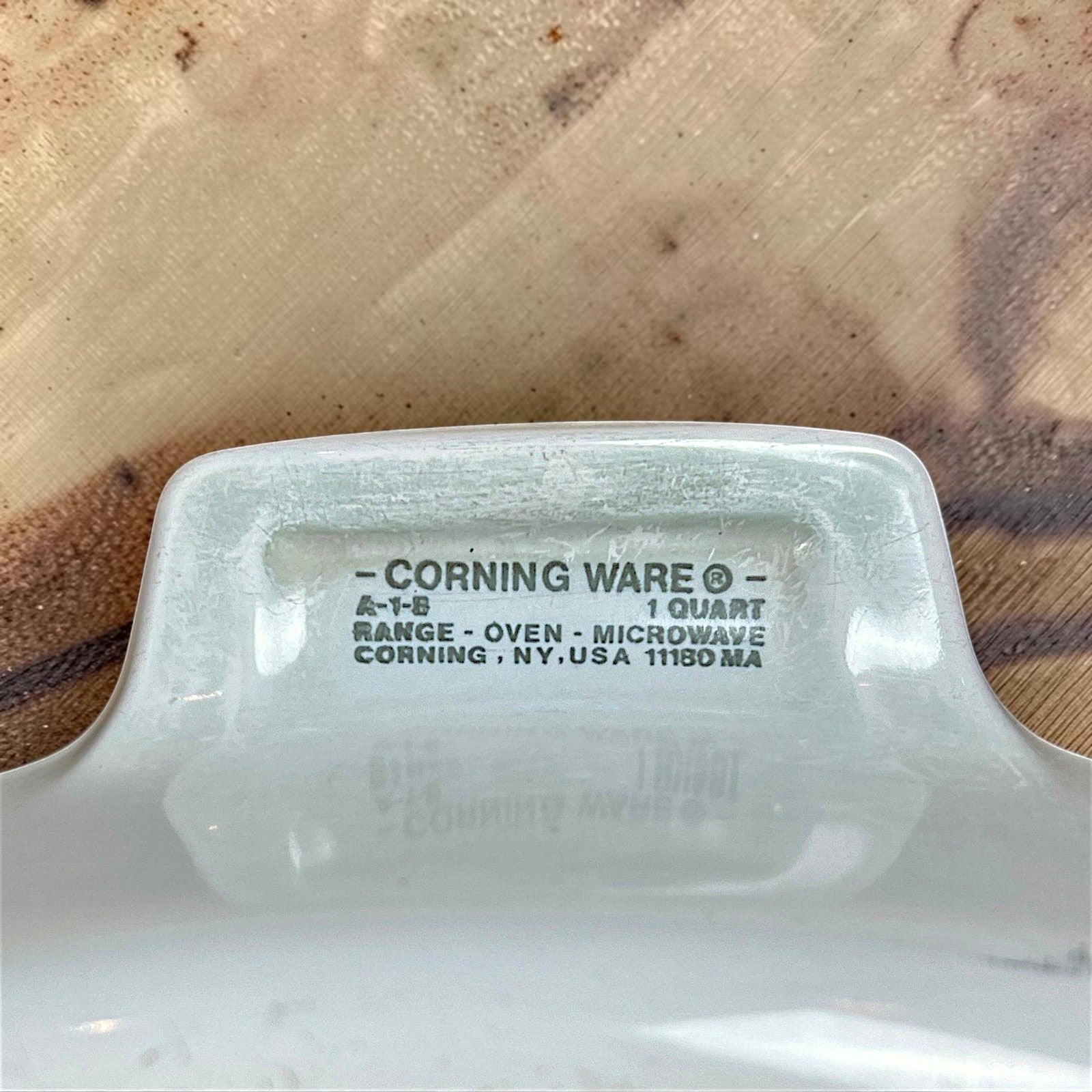 A square white Corning Ware casserole dish with a clear Pyrex glass lid, featuring the colorful 1970s Spice O' Life pattern with shallots and herbs printed on the side. - Photo 2