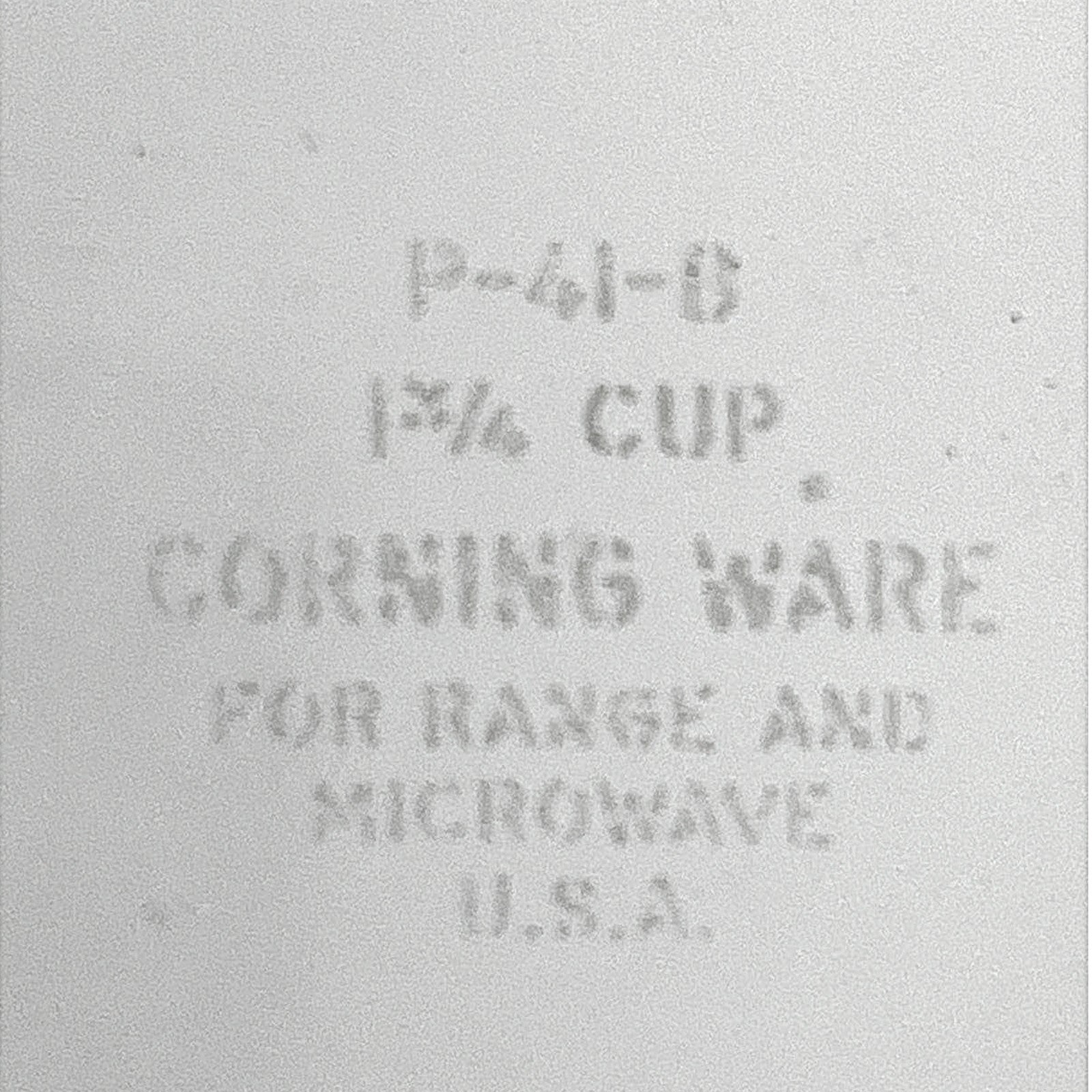 A square-shaped white Corning Ware petite casserole dish with lug handles, resting on a rustic wood slice background. - Photo 3