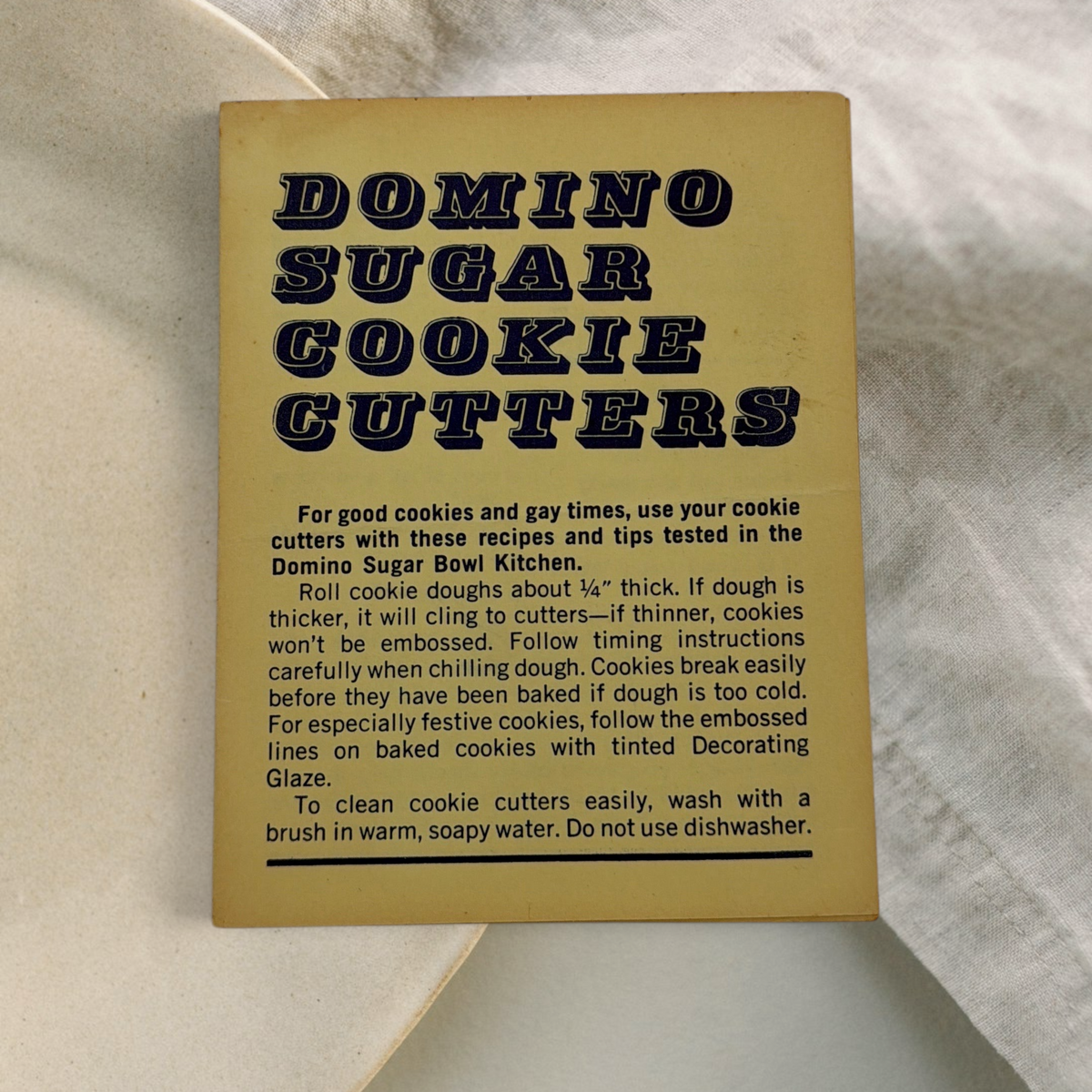 Front and inside view of vintage yellow Domino Sugar Cookie Cutters recipe pamphlet showing holiday and carnival recipes. - Photo 1