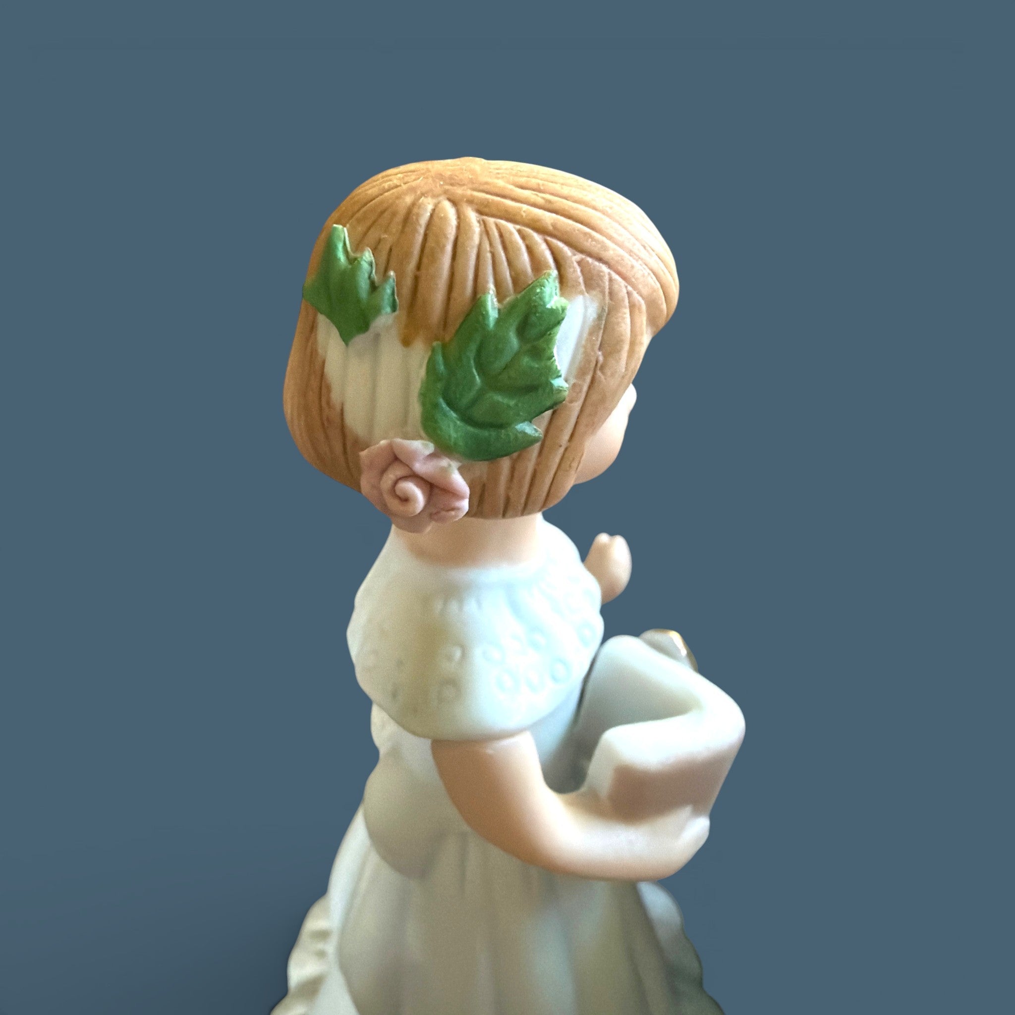 Vintage Enesco Growing Up Girls Age 6 porcelain figurine showing a fair child wearing a delicate white floor-length dress decorated with a classic high collar, a soft ruffled hemline, and a prominent bow tied at the back. - Photo 2