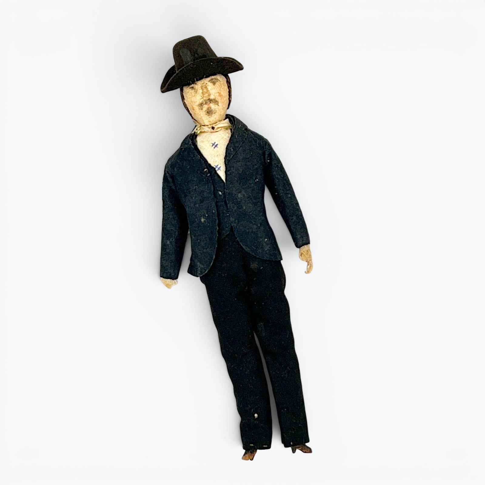 A vintage German miniature bendable dollhouse doll depicting a man in a traditional black suit and wide-brimmed black hat. - Photo 1