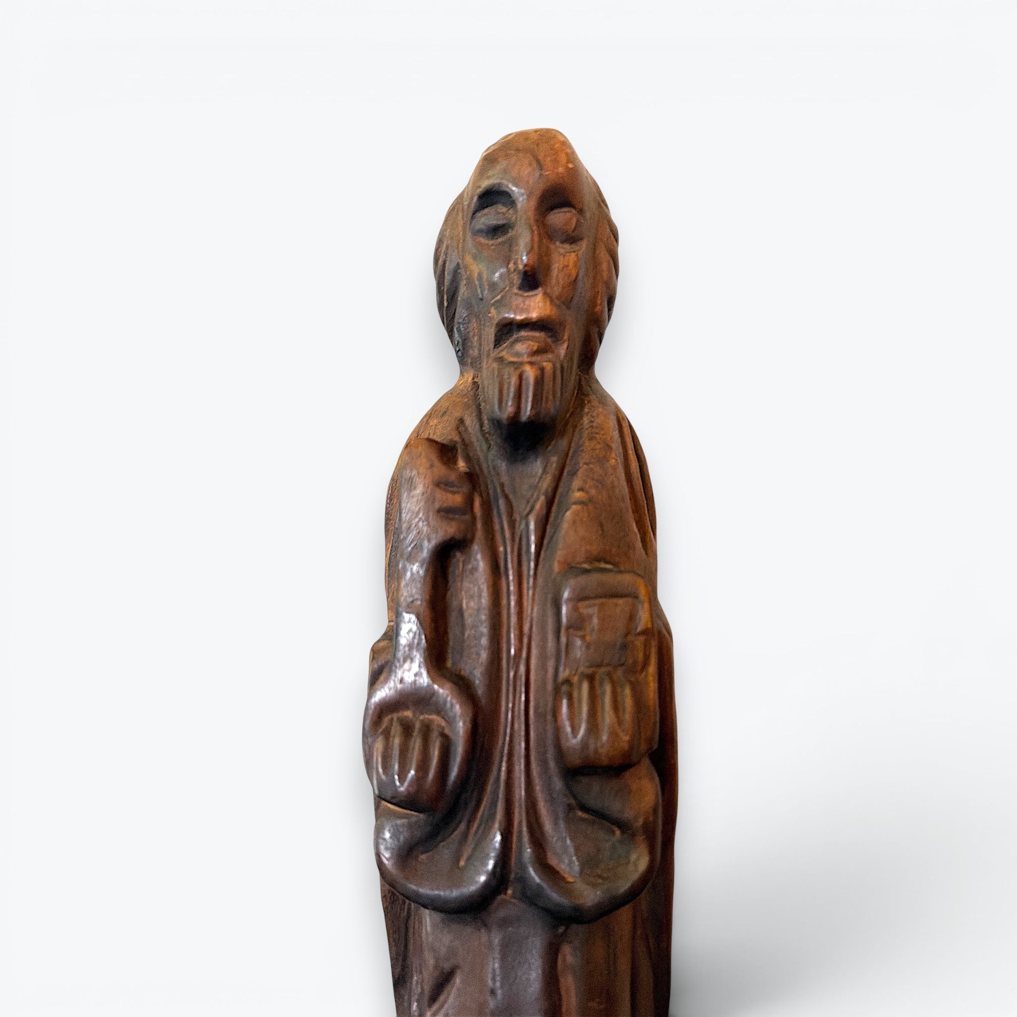 A rustic, hand-carved wooden religious saint figurine standing on a pegged base, featuring intricate carved details of robes, a beard, and symbolic items. - Photo 3