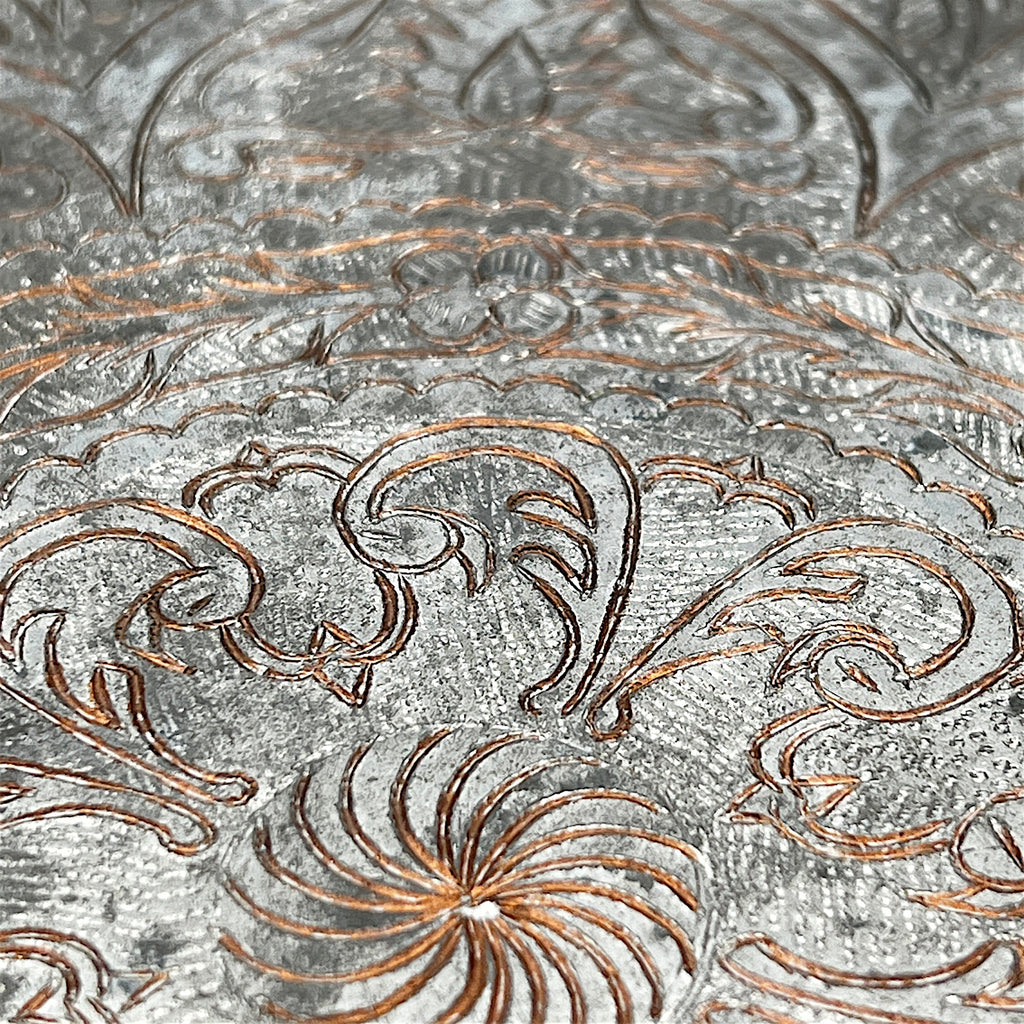 An octagonal tinned copper tray featuring intricate hand-chased Persian floral scrollwork, an elaborate eight-pointed star medallion, and a scalloped rim. - Photo 3