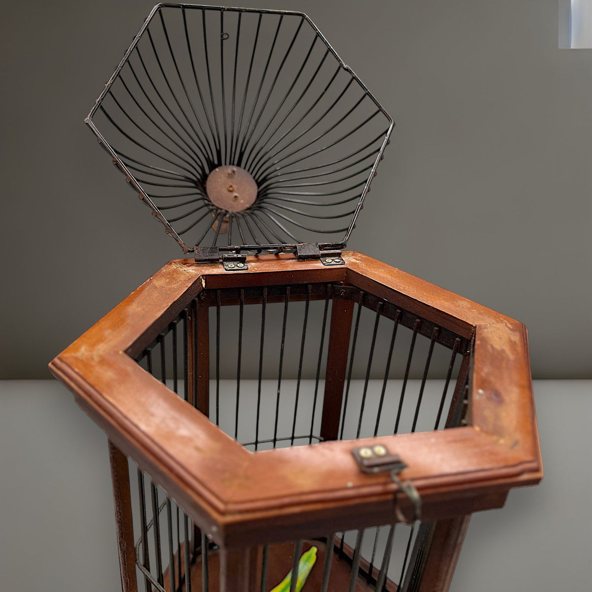 Hexagonal wood and wire decorative birdcage with a dark wooden frame, thin vertical metal bars, and a hinged wire top lid held open. - Photo 9