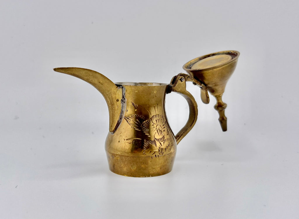 A miniature vintage brass dallah coffee pot featuring hand-chased floral engravings, an elongated curved spout, a rounded body, a side handle, and a hinged conical lid. - Photo 3