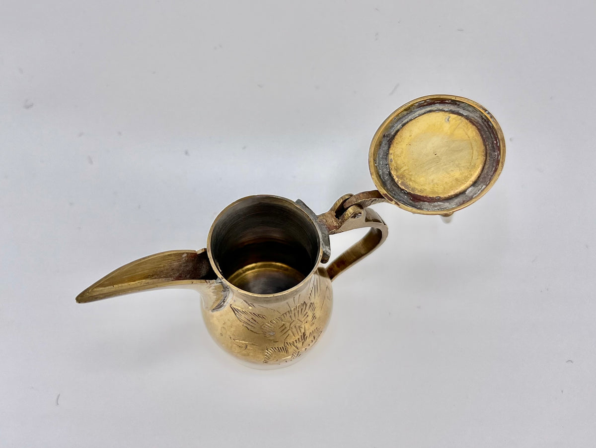 A miniature vintage brass dallah coffee pot featuring hand-chased floral engravings, an elongated curved spout, a rounded body, a side handle, and a hinged conical lid. - Photo 4