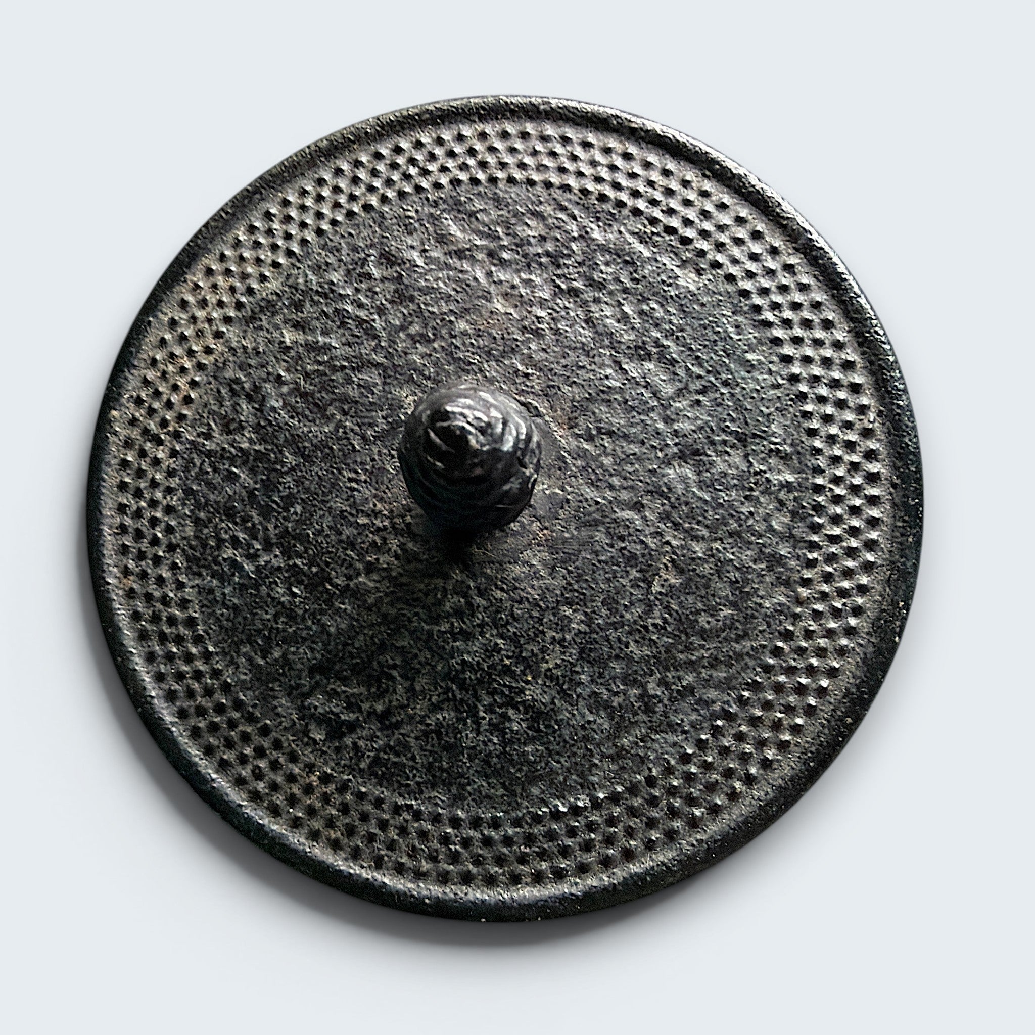 A black cast iron tetsubin teapot featuring a classic hobnail textured surface, open top showing a stainless steel mesh infuser basket, and two pivoting black metal handle hinges on the sides. - Photo 6