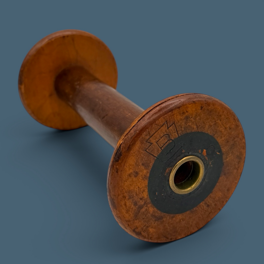 An antique wooden industrial bobbin with a rich brown finish, a thick central spindle, and two wide circular flanges at the top and bottom. - Photo 1