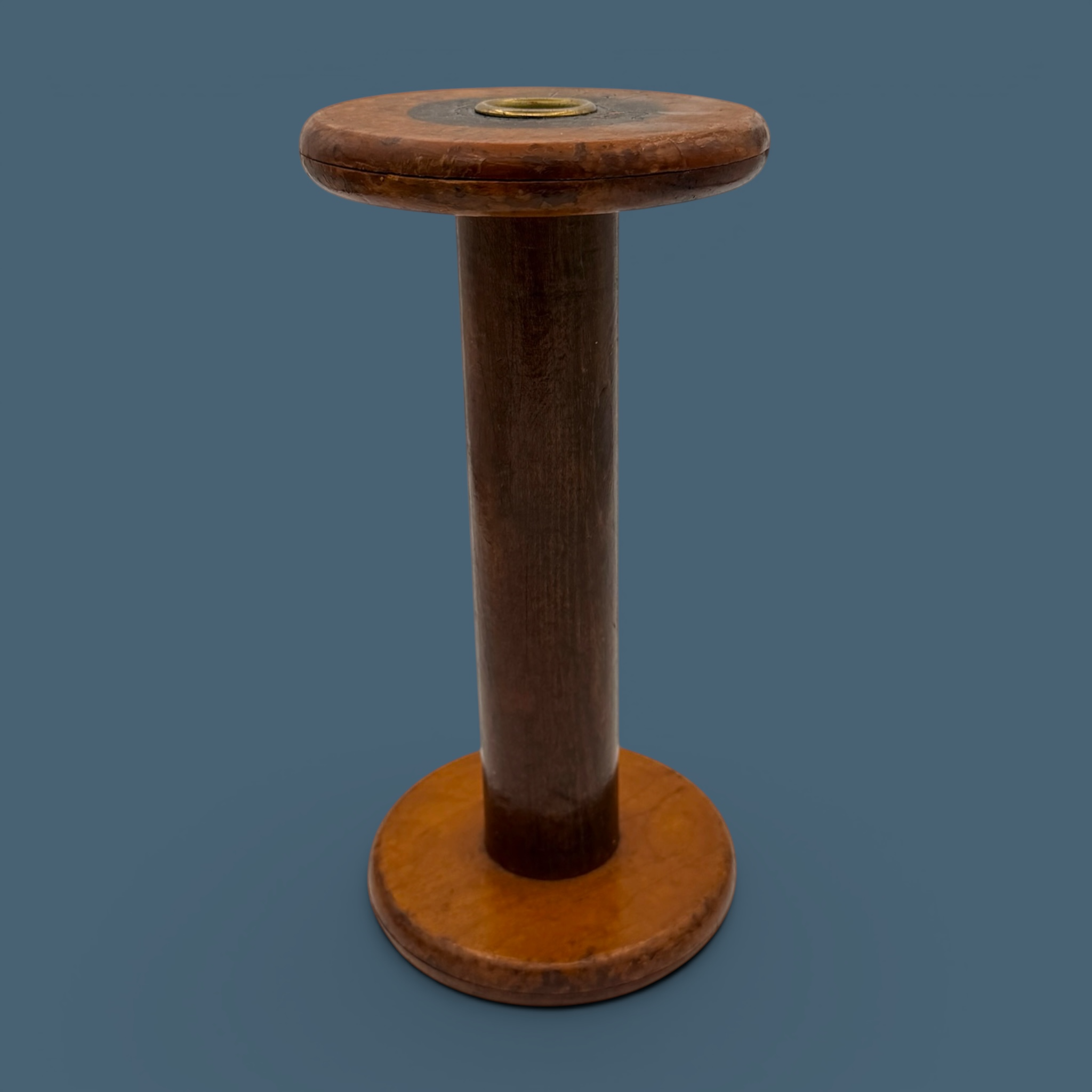 An antique wooden industrial bobbin with a rich brown finish, a thick central spindle, and two wide circular flanges at the top and bottom. - Photo 2
