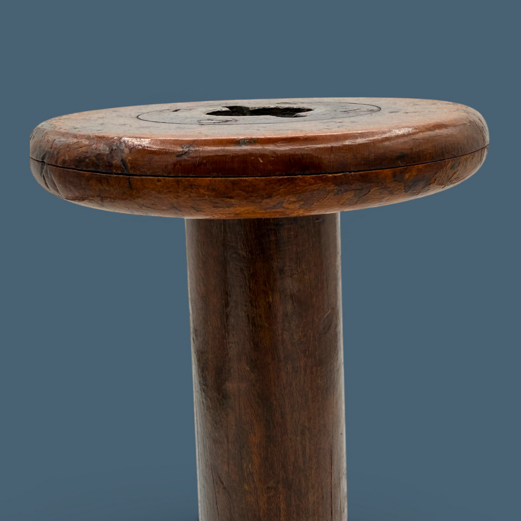An antique wooden industrial bobbin with a rich brown finish, a thick central spindle, and two wide circular flanges at the top and bottom. - Photo 3