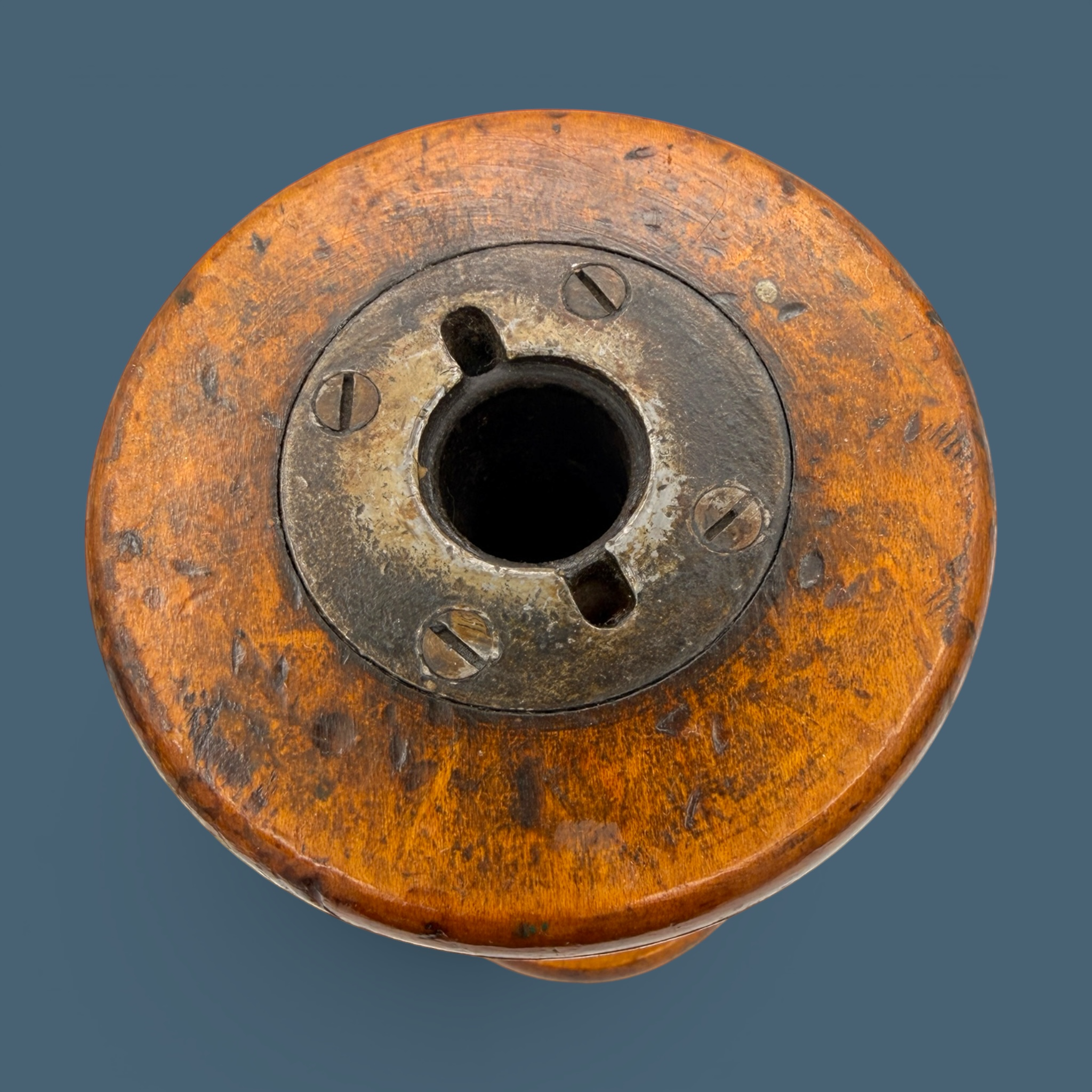 An antique wooden industrial bobbin with a rich brown finish, a thick central spindle, and two wide circular flanges at the top and bottom. - Photo 4