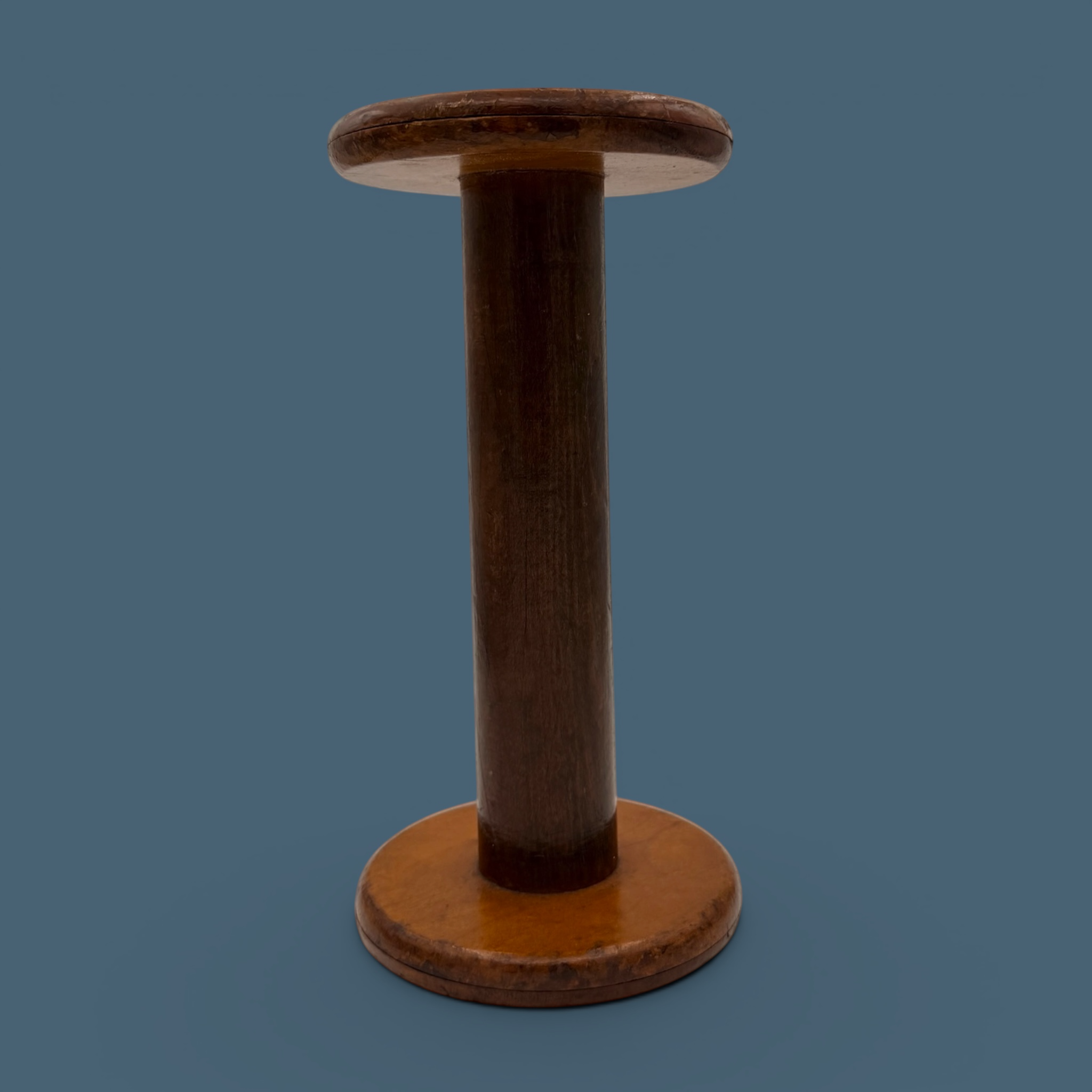 An antique wooden industrial bobbin with a rich brown finish, a thick central spindle, and two wide circular flanges at the top and bottom. - Photo 6