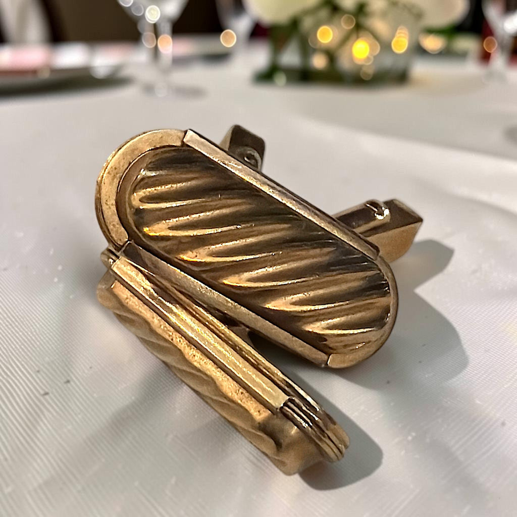 Pair of gold-tone rectangular cufflinks with a diagonal ribbed pattern and swivel toggle back closures. - Photo 1