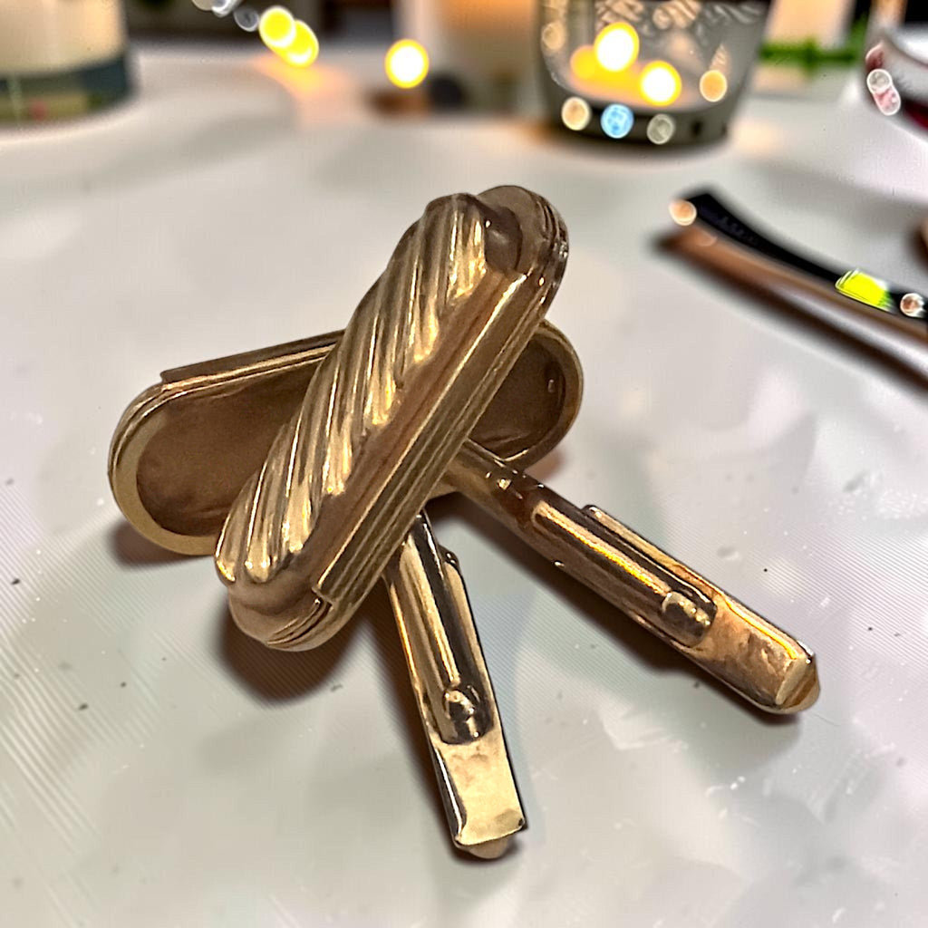Pair of gold-tone rectangular cufflinks with a diagonal ribbed pattern and swivel toggle back closures. - Photo 2