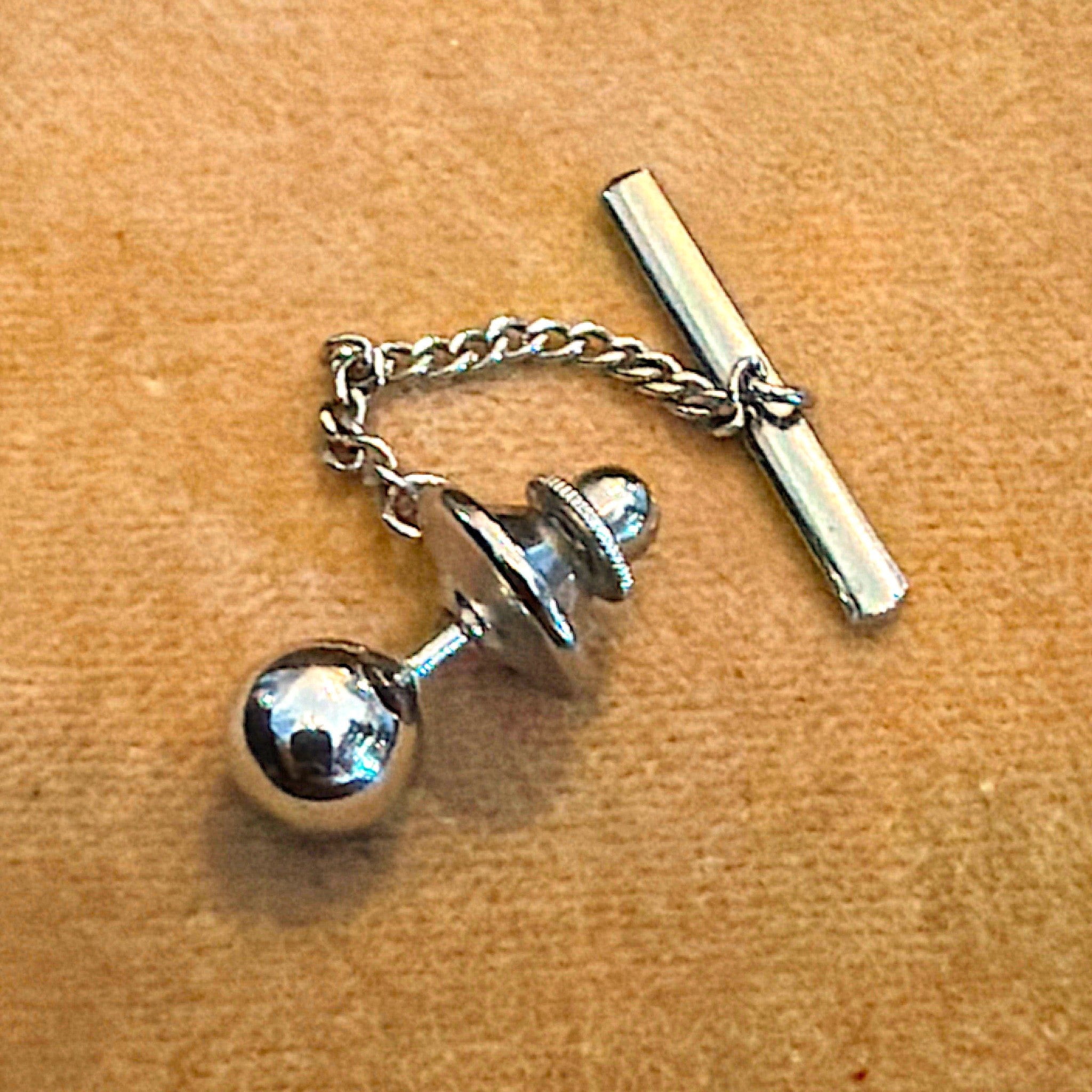 A vintage silver-tone tie tack featuring a polished reflective sphere accent with an attached fine link chain and button bar stay. - Photo 2