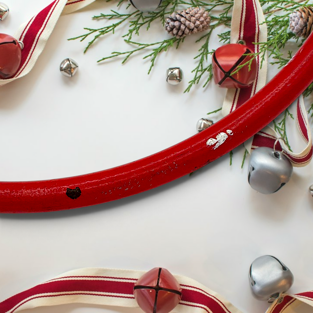 Vintage red painted metal circular hunting horn with flared bell and mouthpiece against a white background - Photo 5