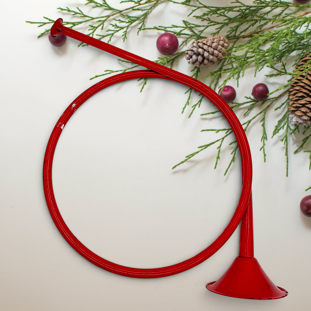 Vintage red painted metal circular hunting horn with flared bell and mouthpiece against a white background - Photo 6