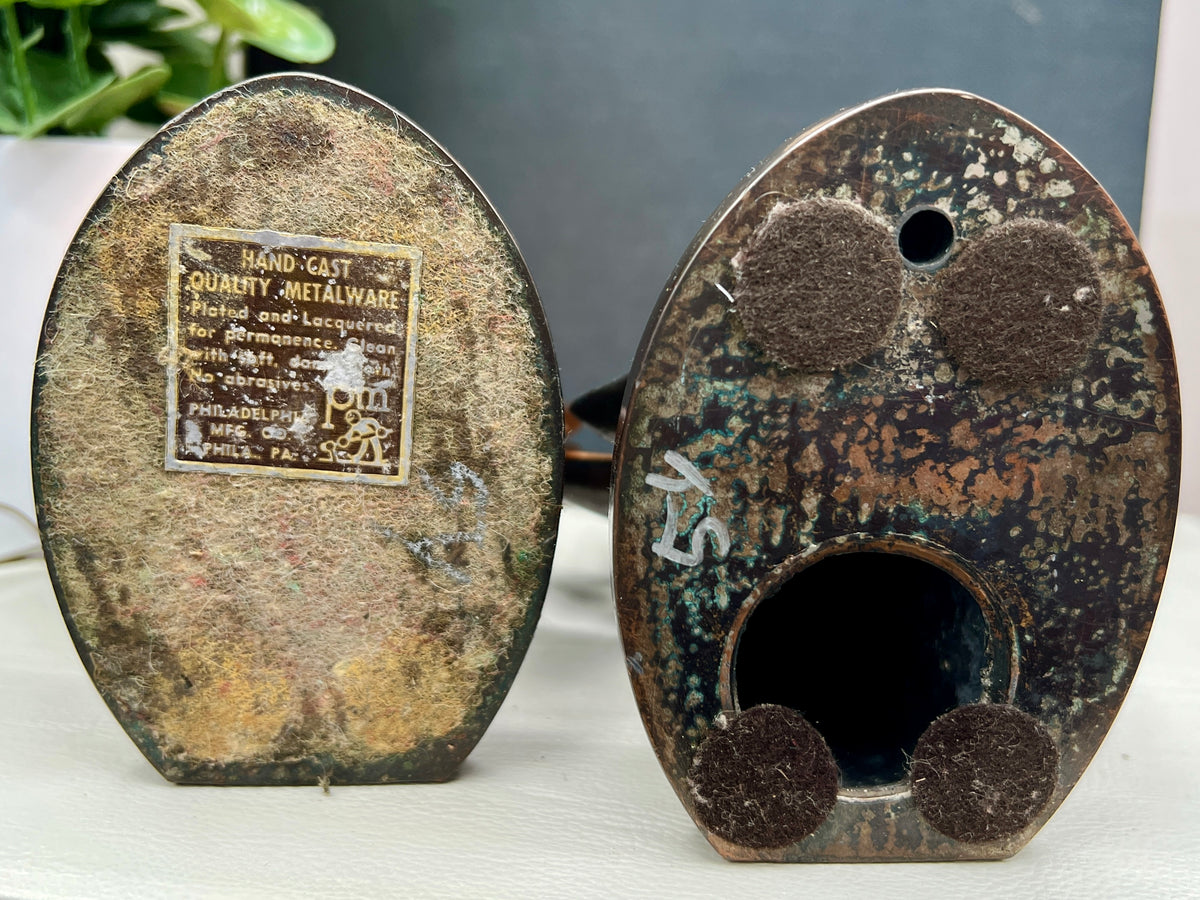 A pair of vintage PMC hand-cast metal oak leaf bookends with a rich bronze finish, designed with stylized lobed leaves and delicate embossed cascading leaf patterns on their curved backs, supporting a dark book on a white surface. - Photo 7