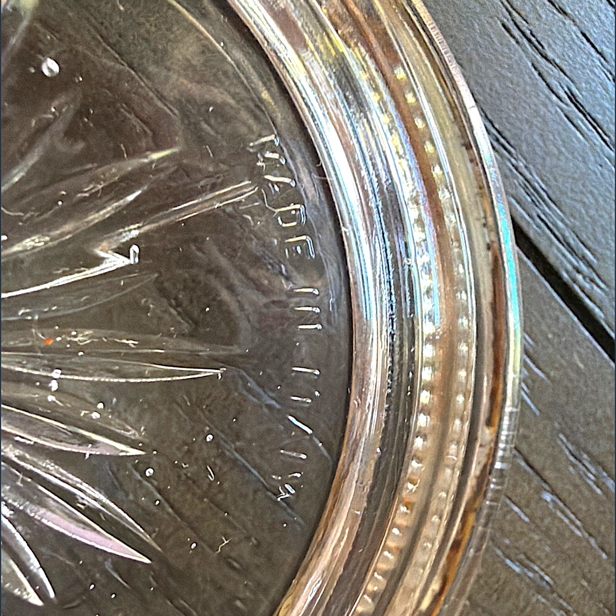 Set of four stacked vintage glass coasters with polished silverplated beaded rims and a clear starburst patterned center. - Photo 3