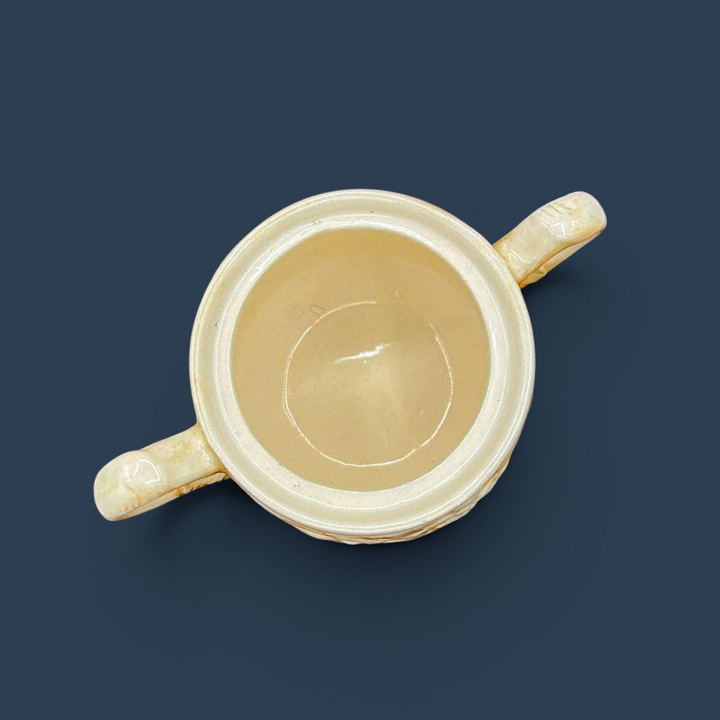 A cream-colored antique ceramic creamer pitcher featuring detailed relief-molded scenes of tavern figures under a smooth glazed finish. - Photo 5