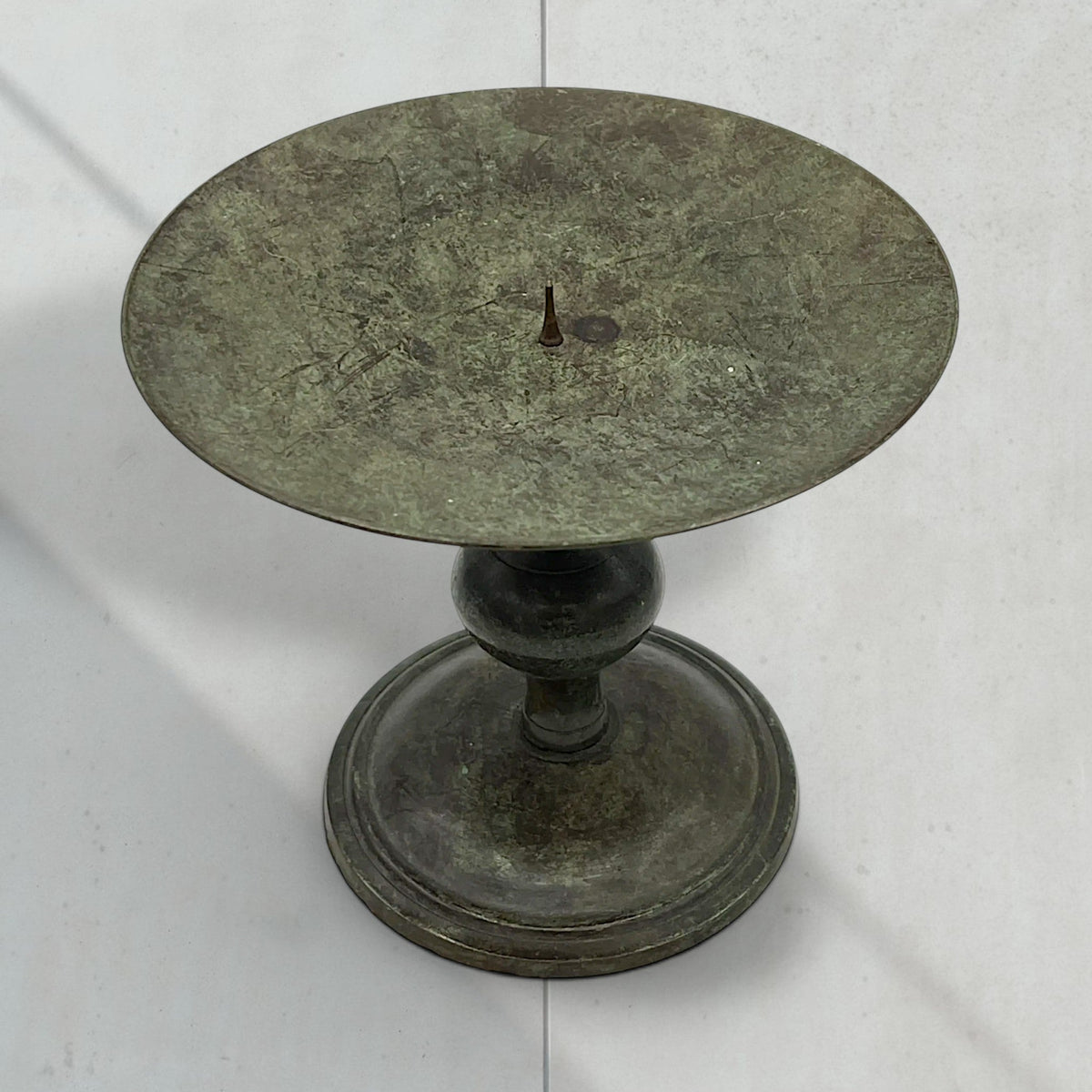 Vintage green verdigris patinated bronze pricket candlestick holder with a wide dished drip pan, central candle spike, and turned baluster stem resting on a circular stepped base. - Photo 4