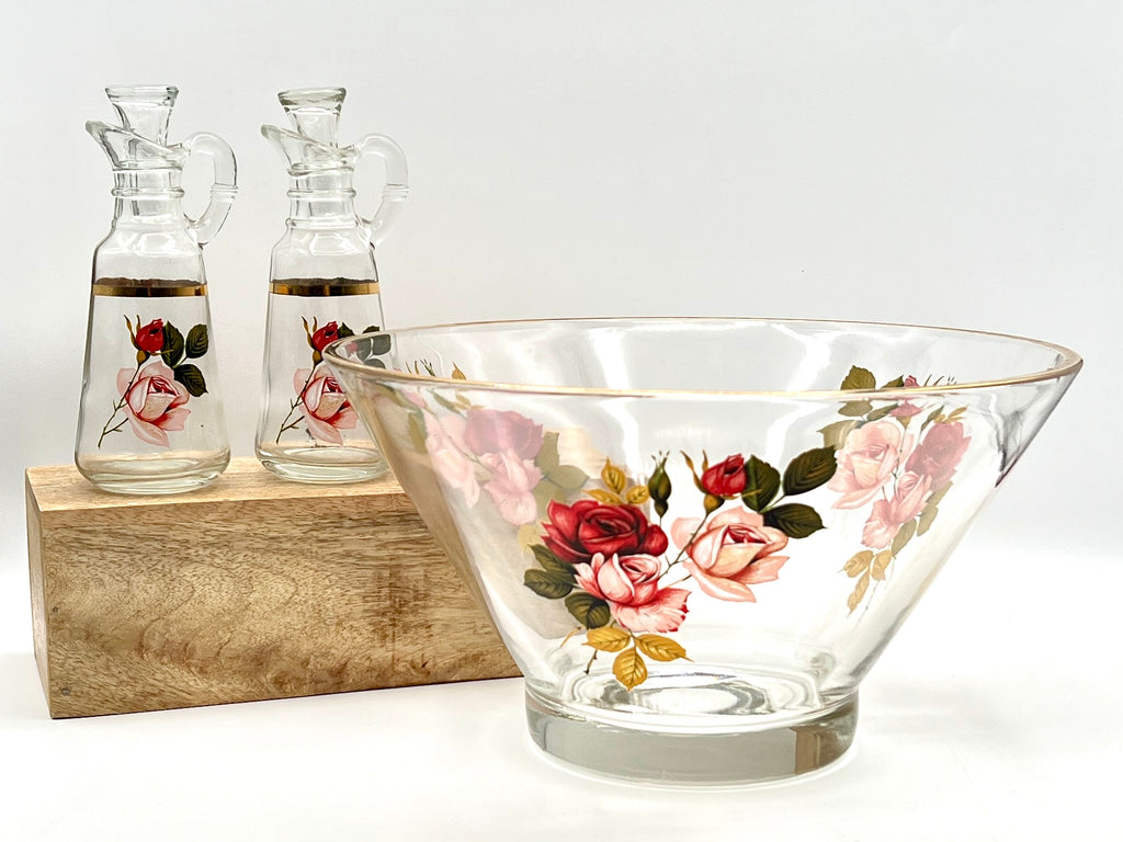 A pair of clear glass cruets with stoppers, featuring hand-painted pink and red roses with green leaves and a gold-gilded band around the neck. - Photo 1
