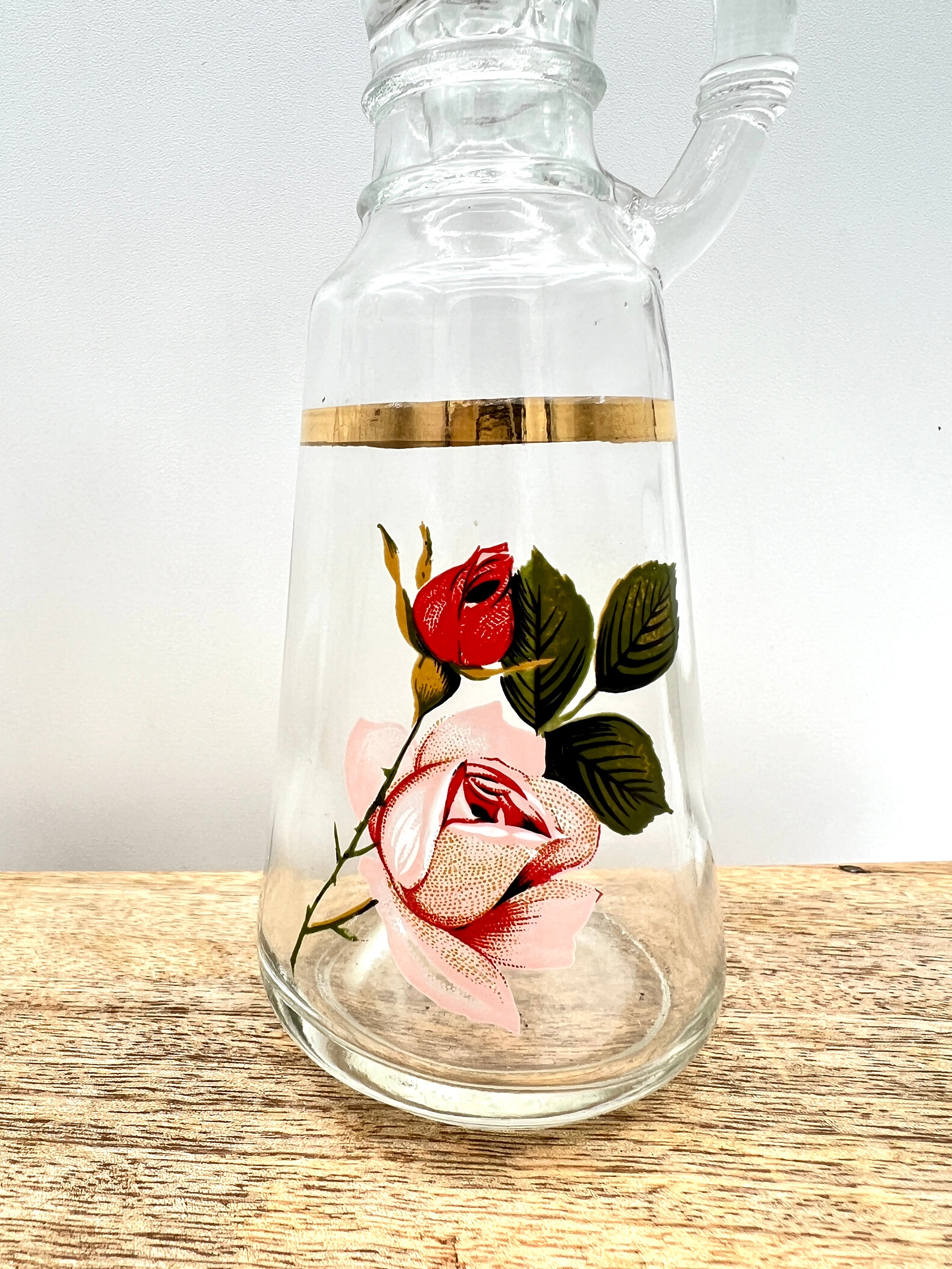 A pair of clear glass cruets with stoppers, featuring hand-painted pink and red roses with green leaves and a gold-gilded band around the neck. - Photo 6