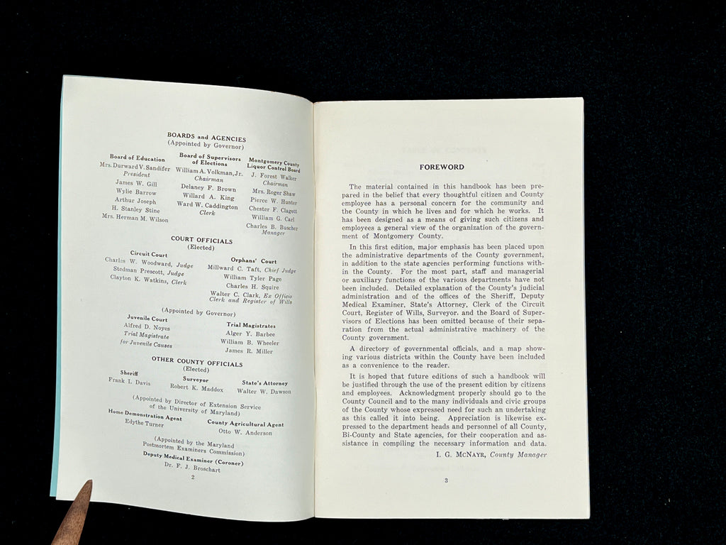 A light blue vintage paper cover of a mid-century Montgomery County Maryland historical publication resting flat on a dark background. - Photo 15